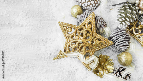 Golden Shiny Christmas Decorations in the Snow with Elegant Ribb