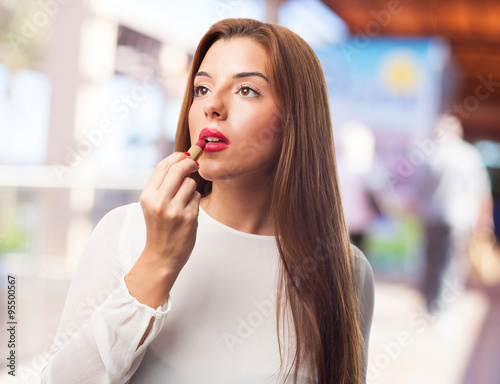 elegant woman using a lipstick