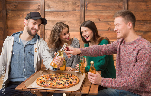 Happy friends resting in pizzeria photo