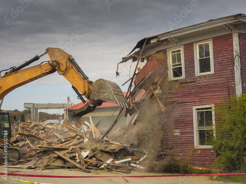 A digger demolishing a house for reconstruction. photo