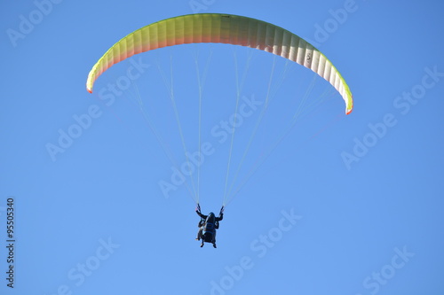 Back view of a couple paragliding
