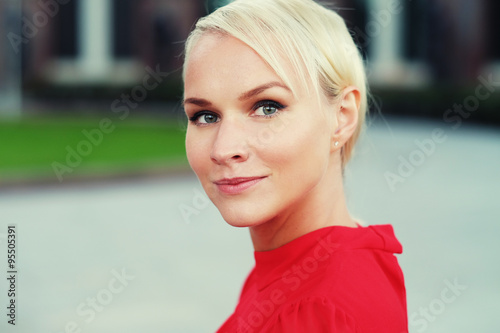 happy young blond woman, wearing red dress