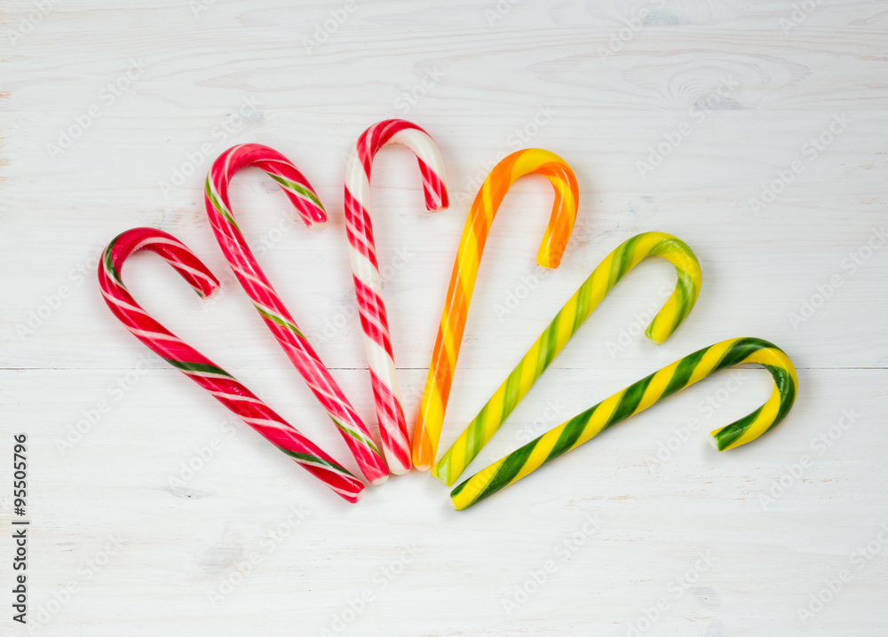 Christmas candy cane on a white wooden background Christmas candy cane on a white wooden background