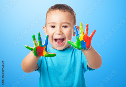portrait of cute kid playing with paint