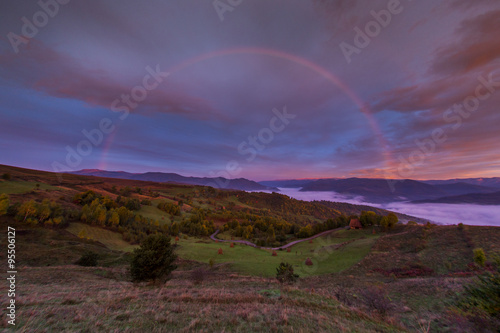 rainbow at sunrise in mountains