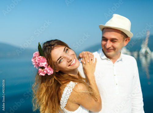 Attractive young couple walking alongside the marina on a luxury
