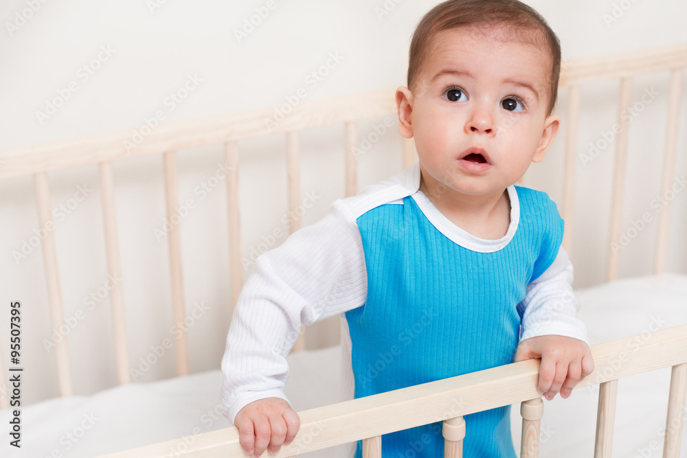 Adorable portrait of cute baby toddler look up on the white bed Adorable portrait of cute baby toddler look up on the white bed