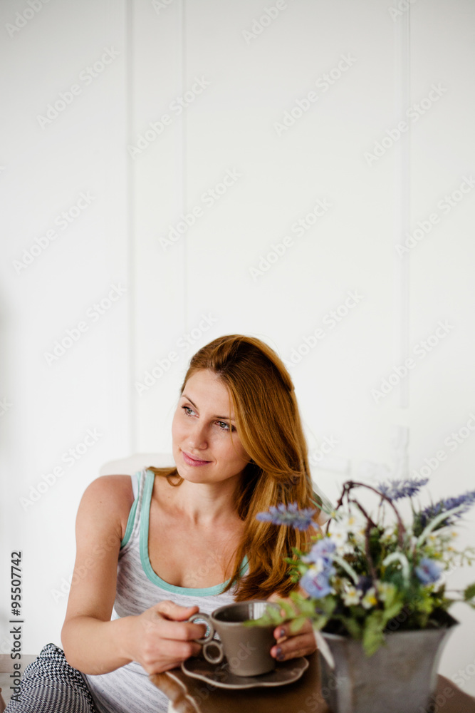 beautiful women with morning coffee sitting in white chair beautiful women with morning coffee sitting in white chair