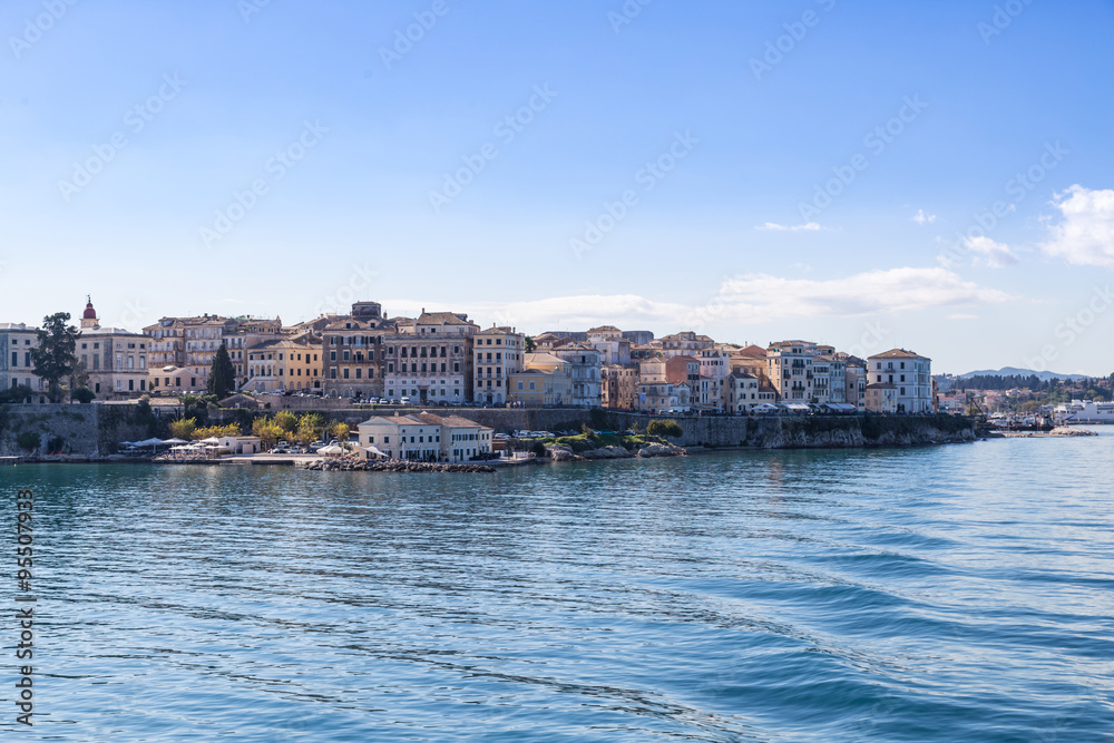 Corfu island cityscape from the sea with blue waters and sky.