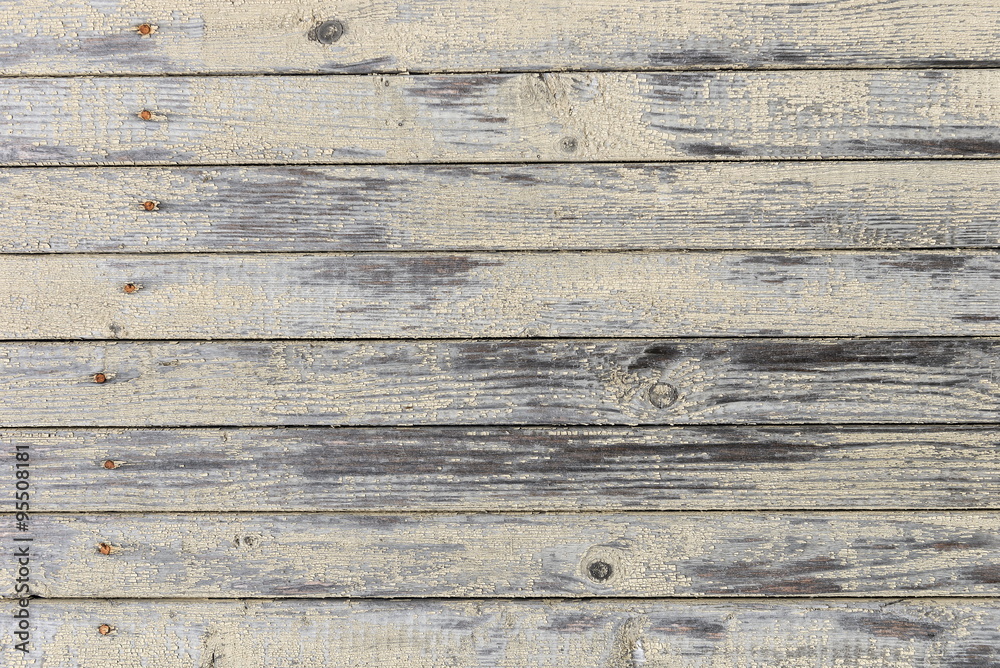 Fototapeta premium old board with the remains of a light yellow paint