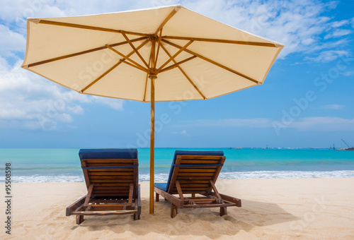 Fototapeta Naklejka Na Ścianę i Meble -  Beach chairs with umbrella and beach on a sunny day