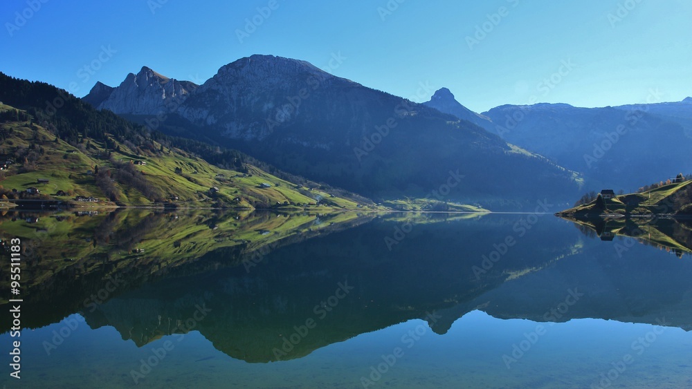 Beautiful shaped mountains mirroring in lake Wagital