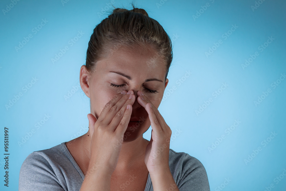 Sinus pain, sinus pressure, sinusitis. Sad woman holding her nos Sinus pain, sinus pressure, sinusitis. Sad woman holding her nos