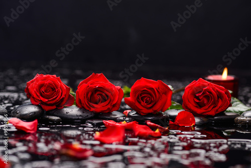 red rose with candle and therapy stones 