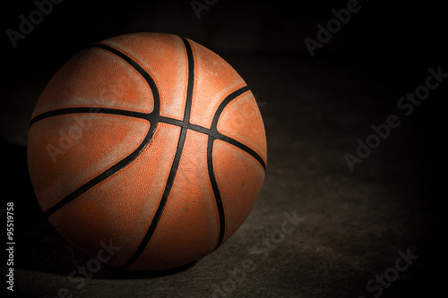 Old basketball on dark background © skynet