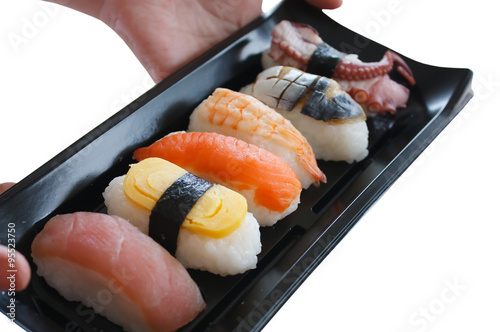 hand holding sushi plate isolated on white background