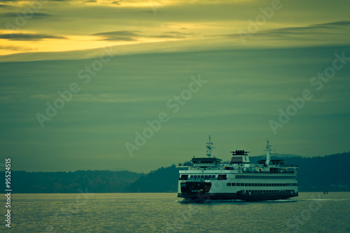 Crossing the Sound / A ferry crosses the Puget Sound near Seattle as the sun sets.