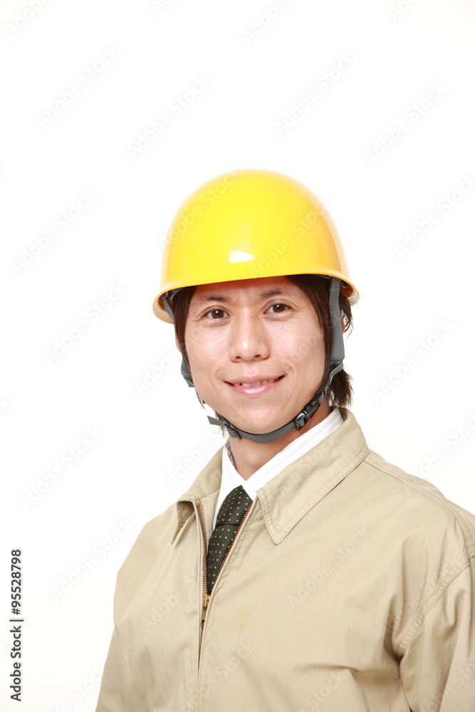 young Japanese construction worker smiles young Japanese construction worker smiles