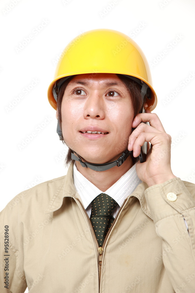 Young construction worker with smart phone Young construction worker with smart phone