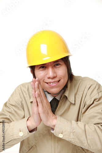 construction worker folding his hands in prayer 