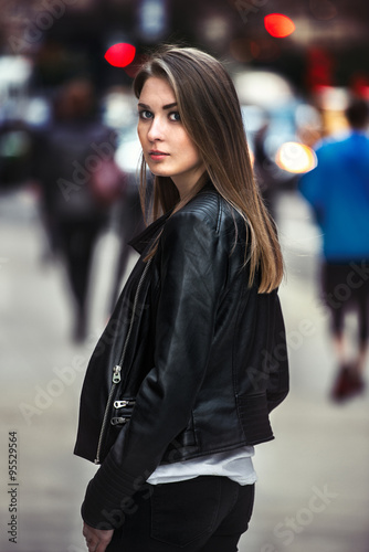 beautiful young woman walking on the crowdy street.