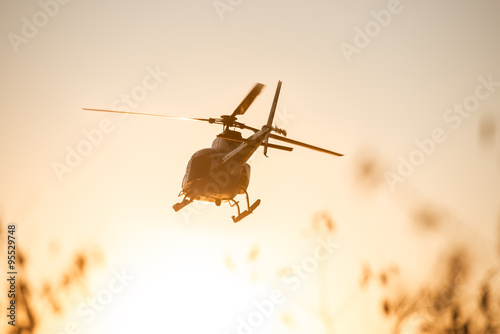 Passanger Helicopter flying in sunset sky
