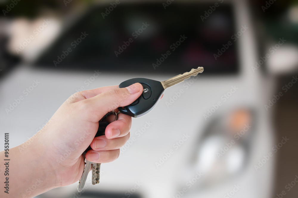 Fototapeta premium women's hand presses on the remote control car alarm systems