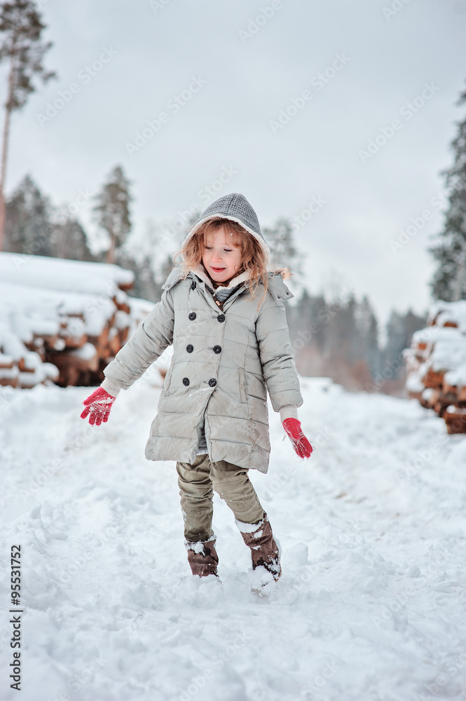cute child girl on the walk in snowy forest on winter holidays cute child girl on the walk in snowy forest on winter holidays