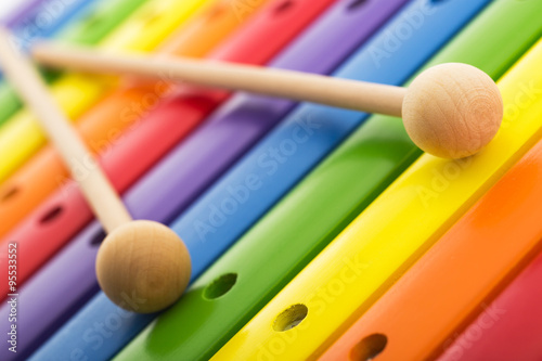 Tableau sur toile Rainbow colored wooden toy xylophone texture against white backg