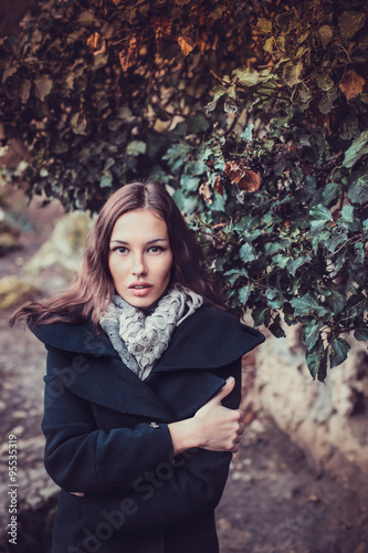 Fashion woman walking in dark autumn park