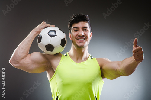 Muscular man with football ball © Elnur