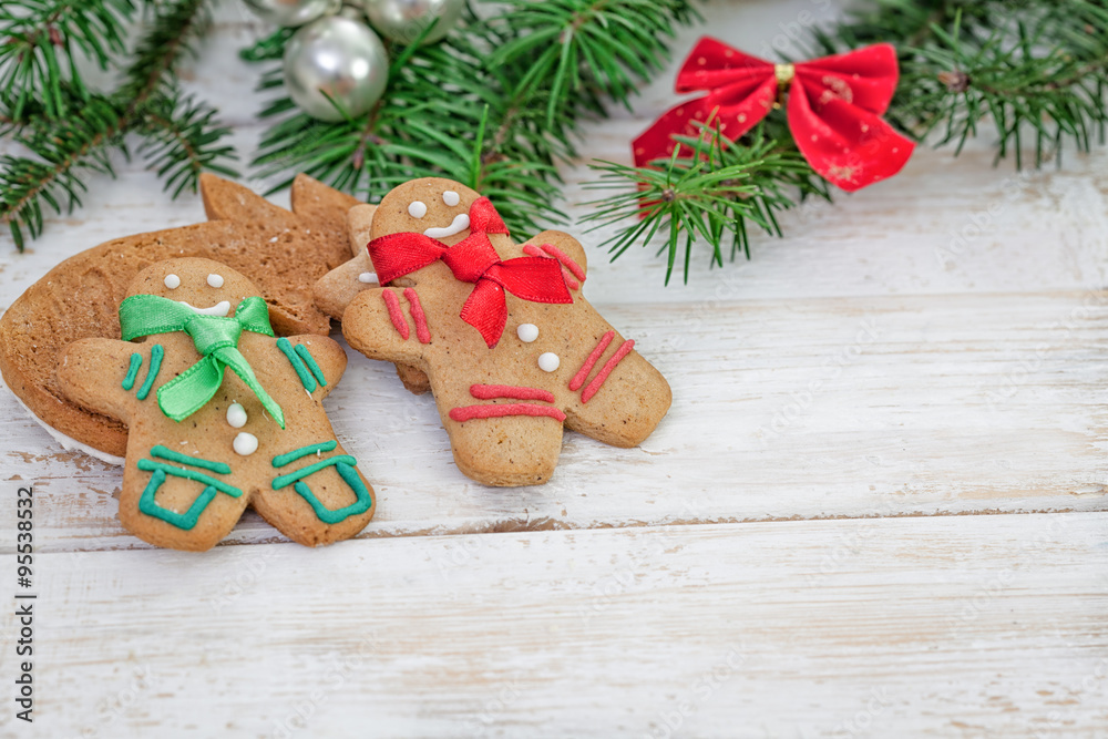 Christmas gingerbread cookie couple on white wooden board with copy space