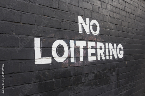 No Loitering sign painted on wall