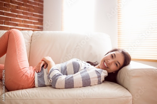 Asian woman relaxing on couch