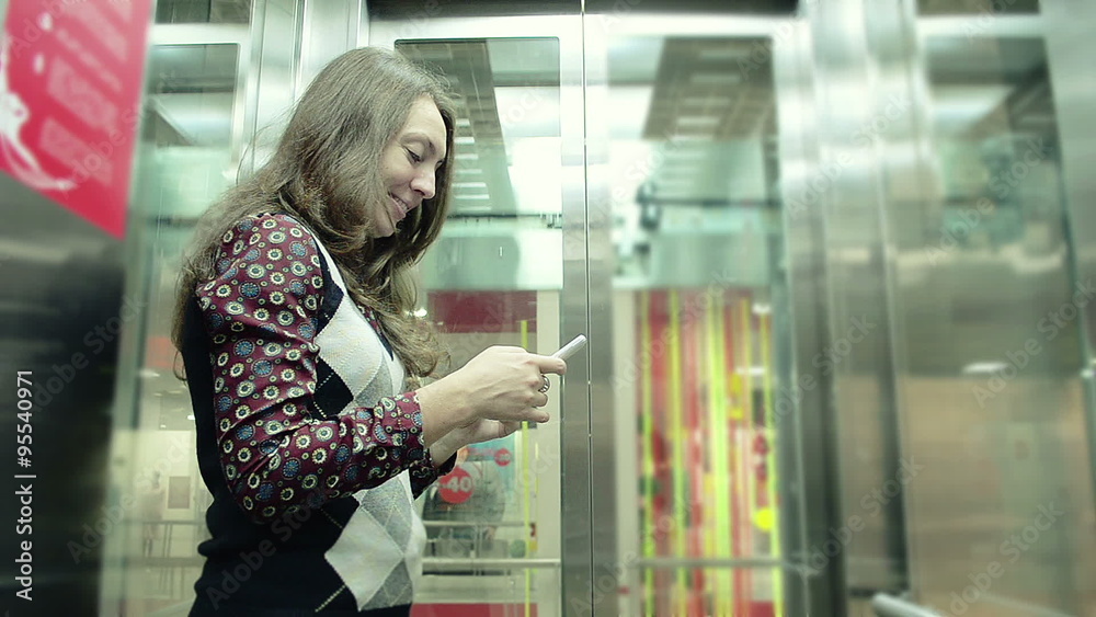 Slow Motion Young Girl Using Smart-Phone In The Elevator Slow Motion Young Girl Using Smart-Phone In The Elevator