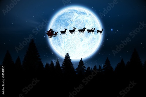 Santa flying over night sky