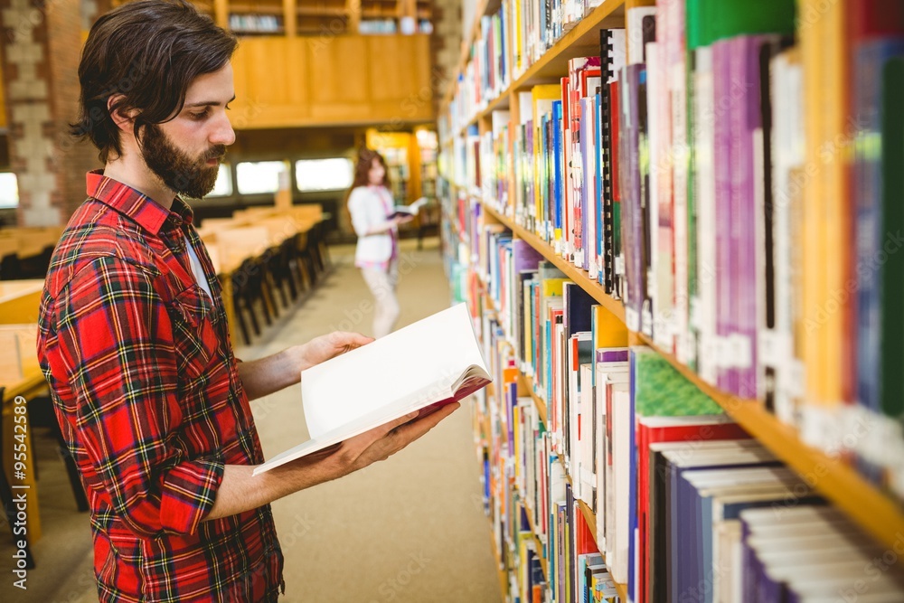Hipster student picking a book in library Hipster student picking a book in library