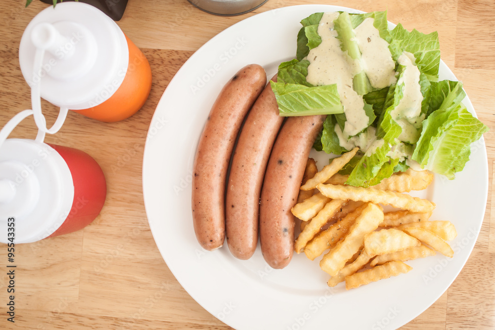 Three pieces of sausage with fresh vegetables, fried potatoes se Three pieces of sausage with fresh vegetables, fried potatoes se