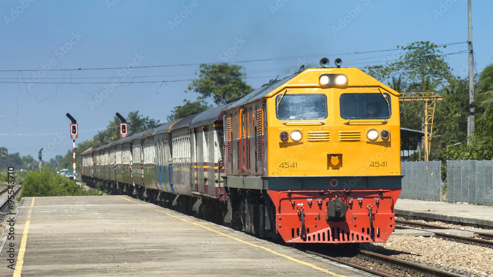 Rapid passenger train was passing through station in suburban, Thailand 2014.