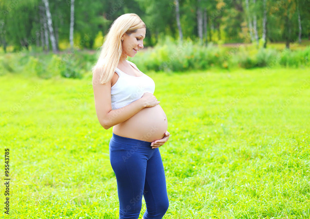 Beautiful young pregnant woman outdoors over summer background, Beautiful young pregnant woman outdoors over summer background,