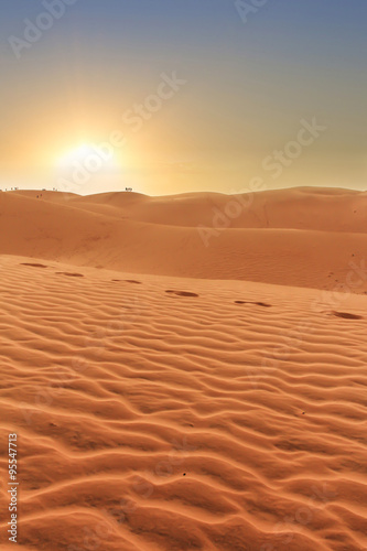 sunset in desert landscpe  footprints in rippled sand