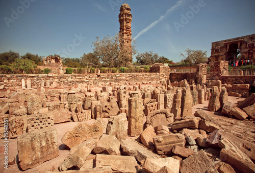 Ruins of hindu temples and tall building of 15th-century Tower of Victory in India, an UNESCO World Heritage Site