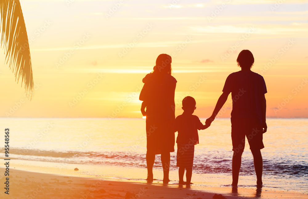 happy family with two kids on sunset beach