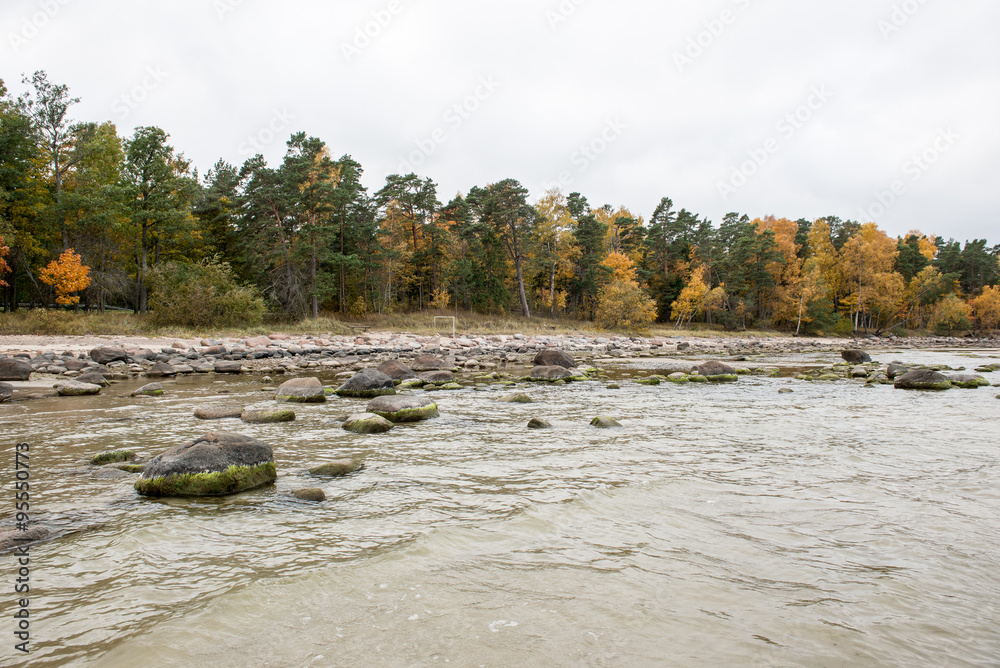 Rocky autumn beach with waves crashing on the rocks Rocky autumn beach with waves crashing on the rocks