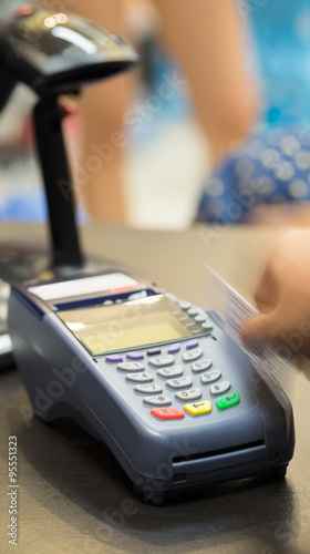 Motion of Hand Swiping Credit Card In Store : Selective Focus