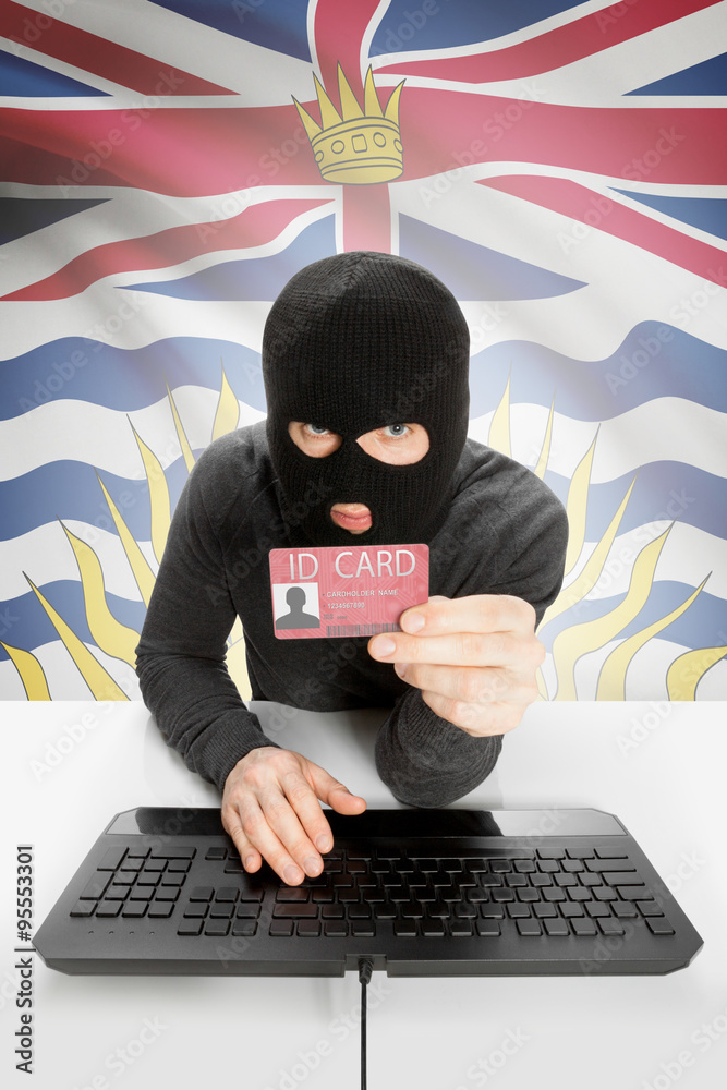 Hacker with Canadian province flag on background holding ID card in hand - British Columbia Hacker with Canadian province flag on background holding ID card in hand - British Columbia