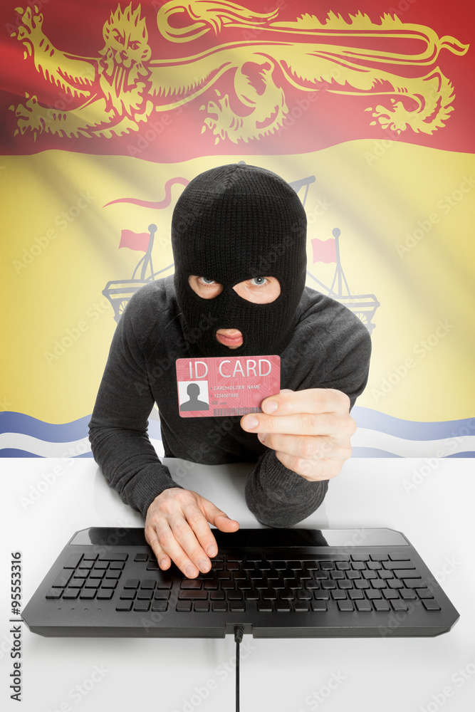 Hacker with Canadian province flag on background holding ID card in hand - New Brunswick Hacker with Canadian province flag on background holding ID card in hand - New Brunswick