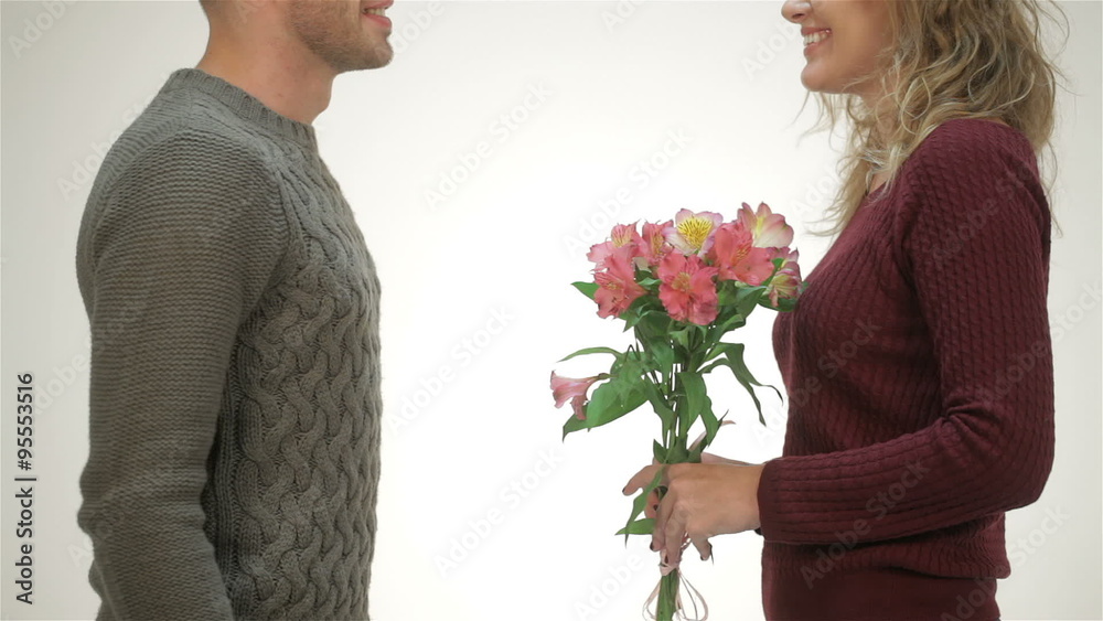 Close up guy presents girl flowers Close up guy presents girl flowers