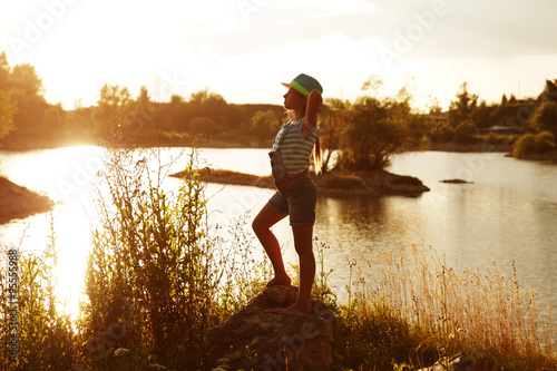 Happy girl on the bank of the river