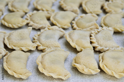 Cheese ravioli lie on the kitchen table